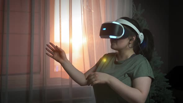 Young excited woman is wearing augmented reality headset, learning software