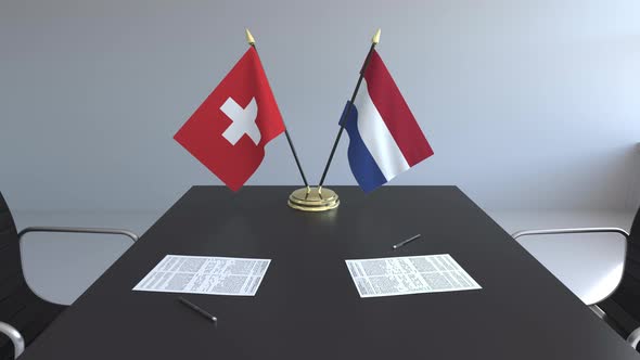 Flags of Switzerland and the Netherlands and Papers
