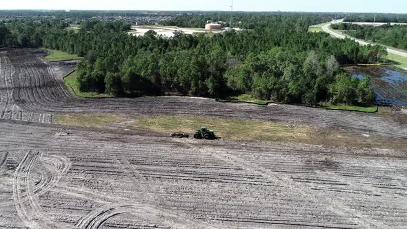 An aerial flyover of a residential site in land development phase to be built as a suburban single f