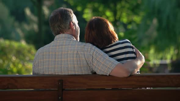 Rear View Romantic Mature Couple Bench Park