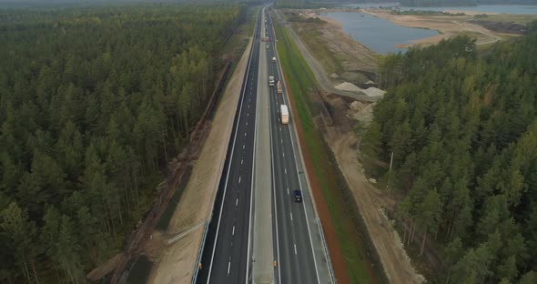 Cars and Trucks Driving on a New Highway Aerial View