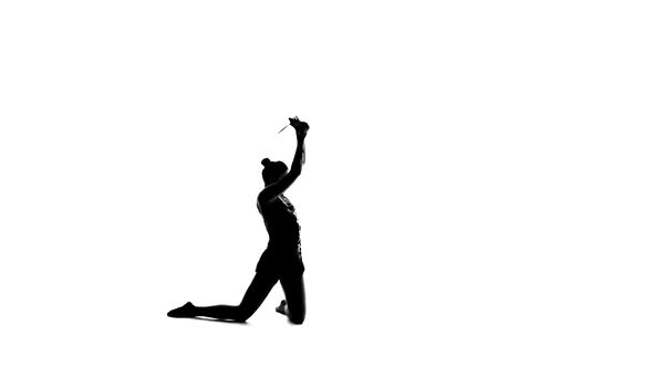 Gymnast Holding a Mace and Professional Bent. White Background. Silhouette. Slow Motion