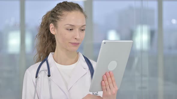 Portrait of Young Female Doctor Doing Video Chat on Tablet