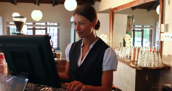 Waitress talking on the phone at counter