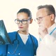 Portrait Of A Serious Doctor And A Beautiful Nurse Holding X-Ray - VideoHive Item for Sale
