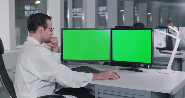 Young Man Scientist Working on Computer in Laboratory