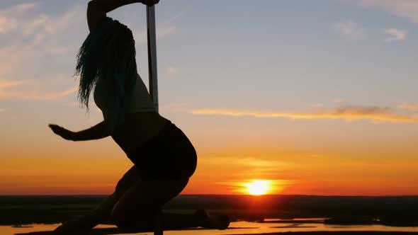 Pole Dance on Sunset - Attractive Woman with Long Blue Braids Dancing