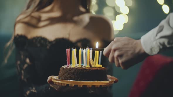 Festive Sweet Cake with Candle Which Lighting on Lighter, Burner or Fire. Close Up of Hands Holding