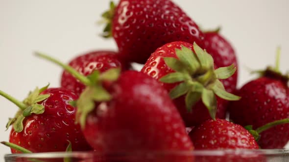 Glass Plate With Ripe Strawberries Rotates, White Background