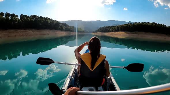 POV of kayakers rowing in slow motion at beautiful lake in the south of Spain