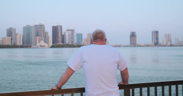 Senior Man Looking at the Bay Standing on the Waterfront Rear View Looking at the Beautiful View