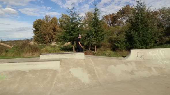 A young skateboarder going off ramps at a skate park.