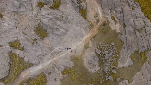 Aerial shot zooming out over hikers, Mount Champaqui, Cordoba Province, Argentina