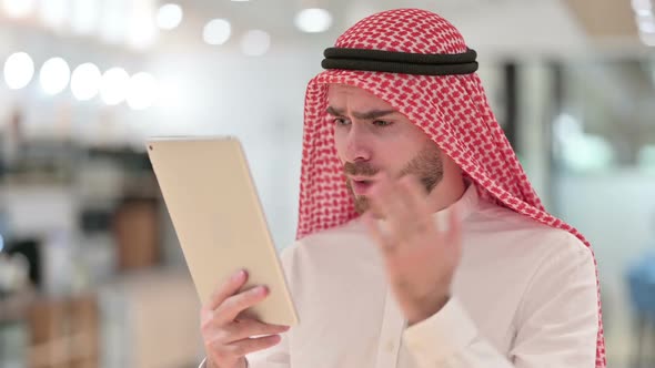 Portrait of Young Arab Businessman Reacting to Loss on Tablet