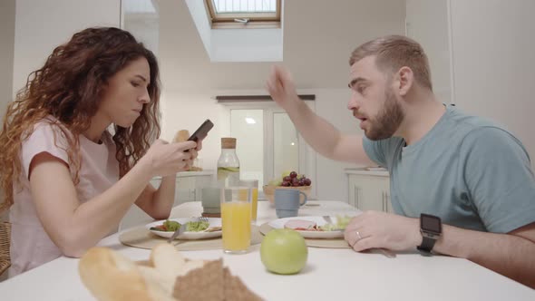 Jealous Husband Confiscating Smartphone from Wife at Lunch and Interrogating Her