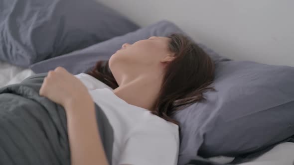 Woman Feeling Uncomfortable While Sleeping in Bed