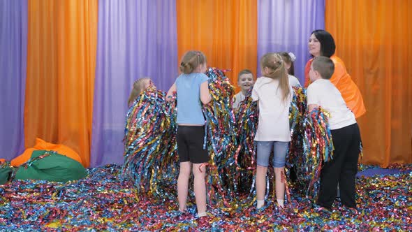 Colored Ribbons Fly in Different Directions, Children Have Fun. Bright Children's Emotions