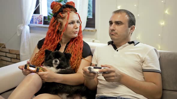 Young Married Couple Plays Computer Games at Home