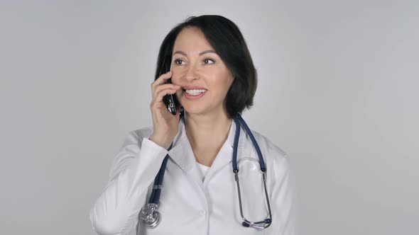 Lady Doctor Talking on Smartphone White Background