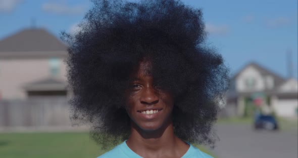 African American adolescent boy with huge Afro looking into the camera