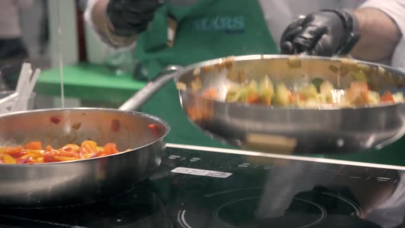 Hands of Cook Frying Vegetables on Pan Colorfull Color Chef Restaurant Catering Close Up