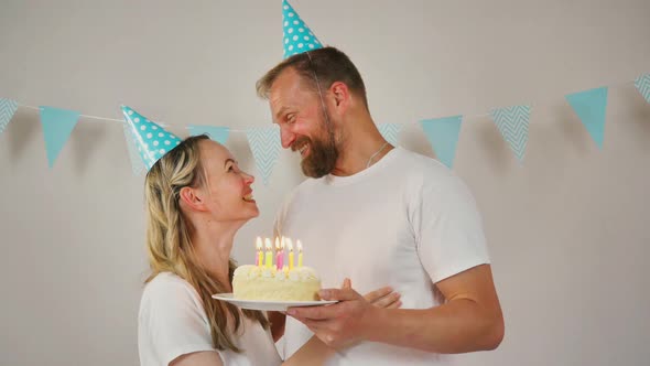 Loving Family Couple Celebrating Anniversary with Cake at Home
