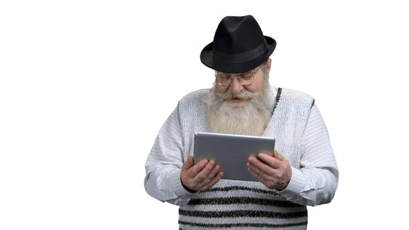 Grandfather Talking with Relatives Via Digital Tablet