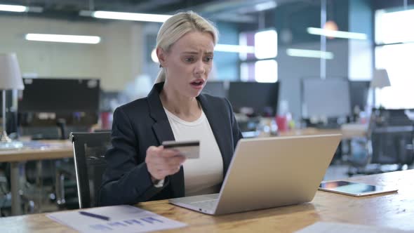 Businesswoman Feeling Annoyed By Online Payment Failure in Office