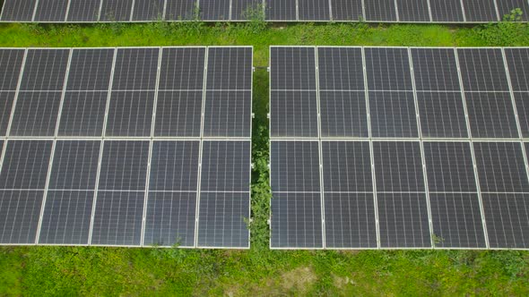 Close Up Aerial view of Solar Panels Farm. Drone flying over Blue Solar Panels Factory