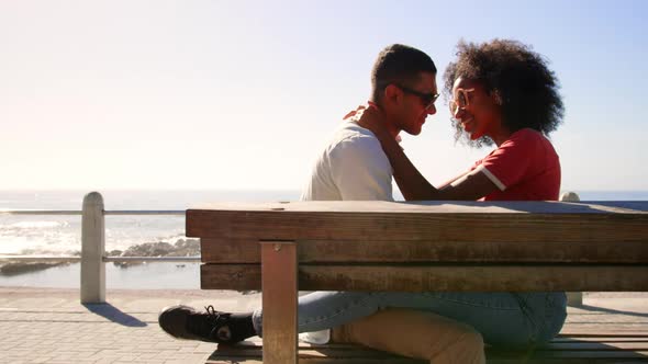 Couple embracing each other on beach promenade in the sunshine 4k