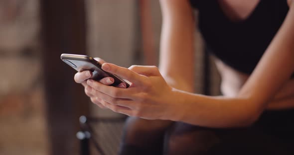 Fit Young Woman Using Smartphone In Gym