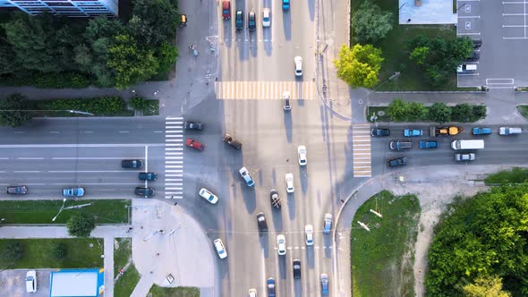 City traffic street crossroad in the rays of the setting sun. Drone footage