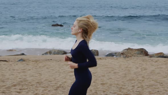 Athletic Woman Is Running On Beach