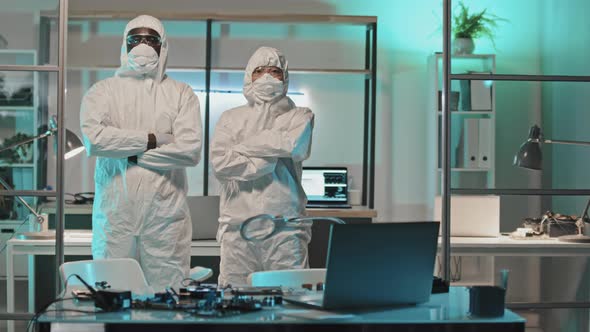 Engineers in Coveralls Posing for Camera in Lab