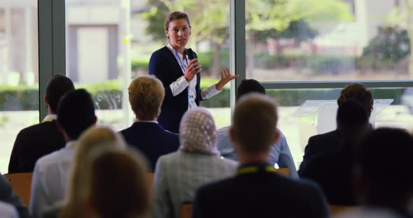 Female speaker speaks in a business seminar at modern office 4k