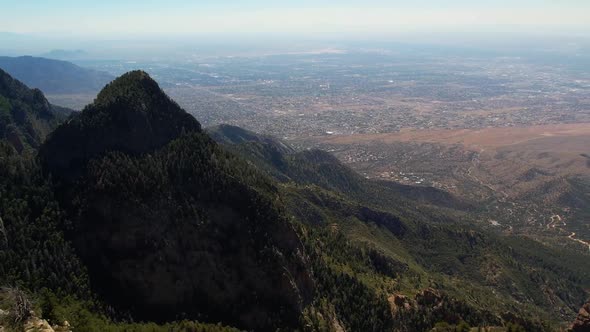 Drone aerial view from the Sandia Mountains of Albuquerque in the distance