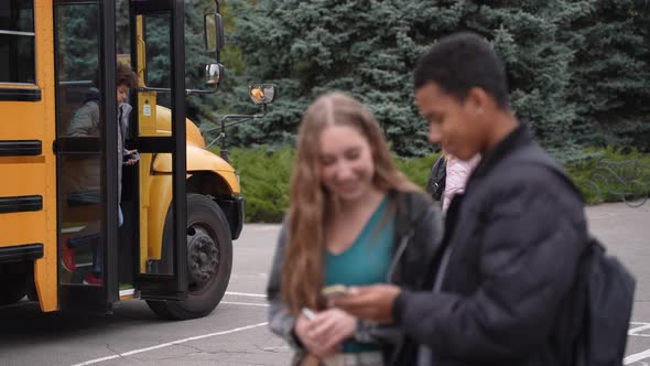 Multinational Pupils Arriving to School By Bus