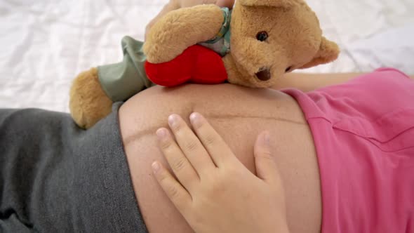 Happy Pregnant Woman Sleeping on Bed in Bedroom