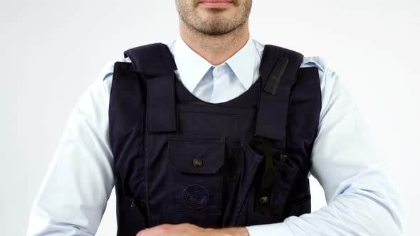 Security guard wearing bulletproof vest on white background