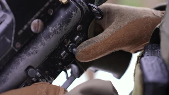 Closeup Male Hand Changing Gun to Safe Mode Outdoors