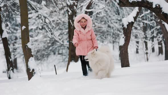 a Child with a Samoyed Dog