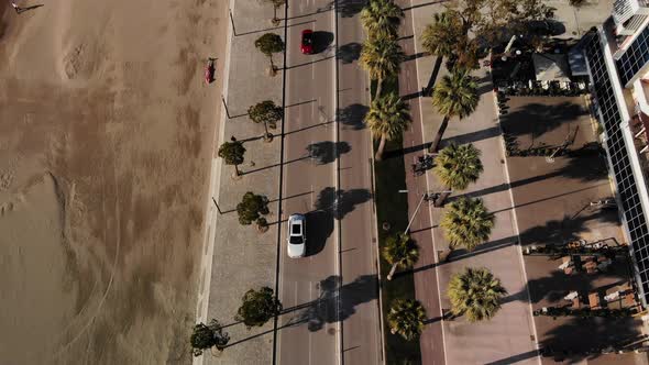 Close Up Top Down View Over Roads with Palm Trees and Few Vehicles