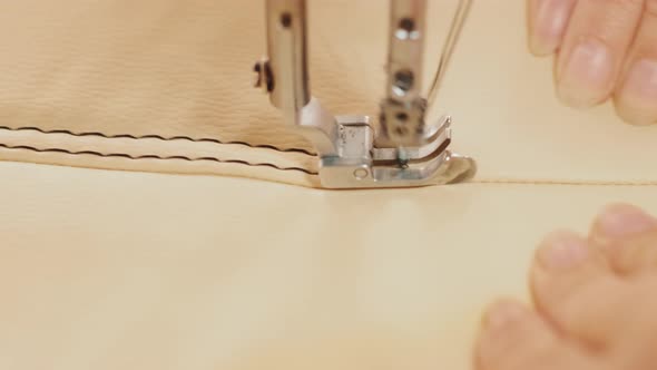 Closeup of sewing machine working part with leather. Cnc sewing machine