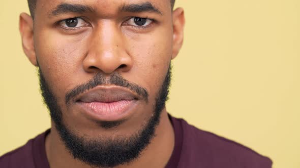 Extreme Closeup Portrait of Confident African American Guy with Hazel Eyes Wearing Sporty Clothes
