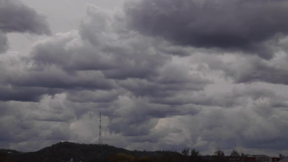 4K time lapse: television tower and beautiful fluffy clouds floating near.