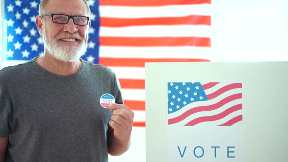An Elderly Man with Glasses Voted in the Elections and Shows a Sticker That Says I Vote. US