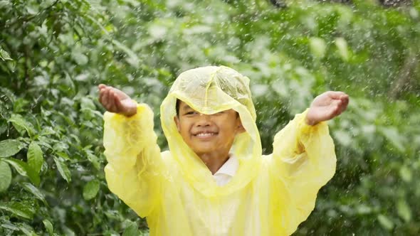 Happy boy wears raincoat
