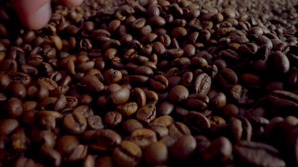 Man Hand Running Coffee Grains Close Up