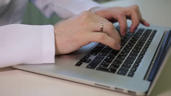 The Doctor Works At The Laptop Keyboard