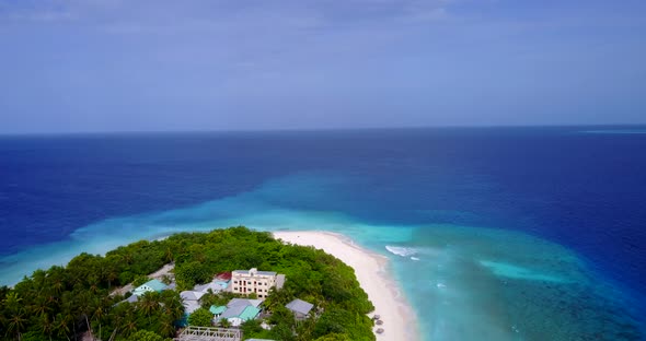 Natural drone island view of a white paradise beach and blue ocean background in vibrant 4K